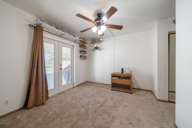 carpeted empty room with french doors and ceiling fan