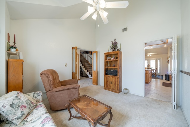 living room with ceiling fan, light tile patterned floors, and high vaulted ceiling