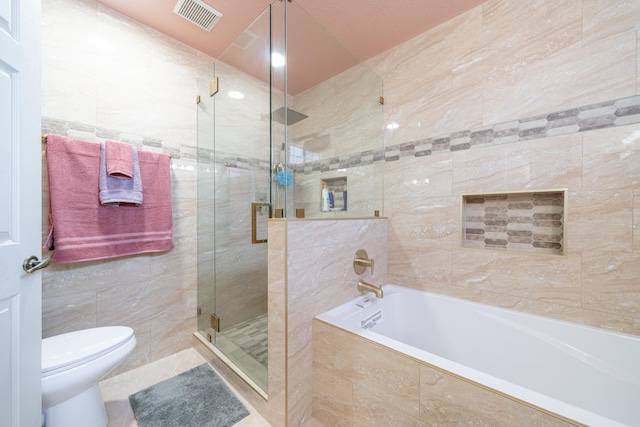 bathroom featuring independent shower and bath, tile walls, and toilet