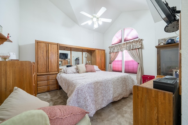 carpeted bedroom featuring ceiling fan and high vaulted ceiling