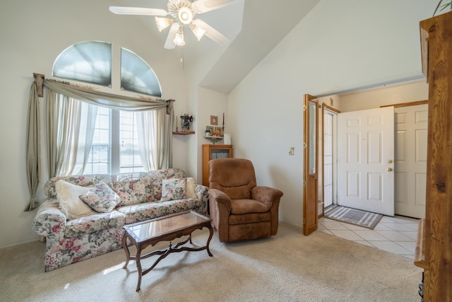 carpeted living room featuring ceiling fan and high vaulted ceiling