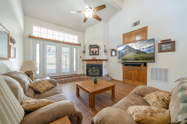 living room featuring ceiling fan, french doors, high vaulted ceiling, and light hardwood / wood-style flooring