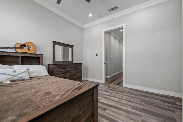 bedroom featuring ceiling fan, hardwood / wood-style floors, and ornamental molding