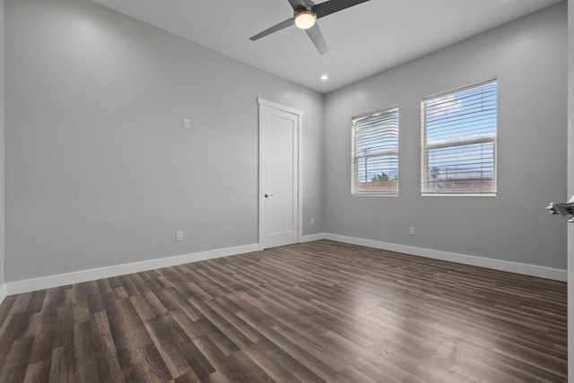 empty room with ceiling fan and dark hardwood / wood-style floors