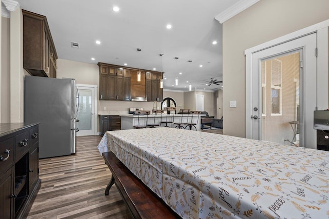 bedroom featuring stainless steel fridge, crown molding, dark hardwood / wood-style floors, and pool table