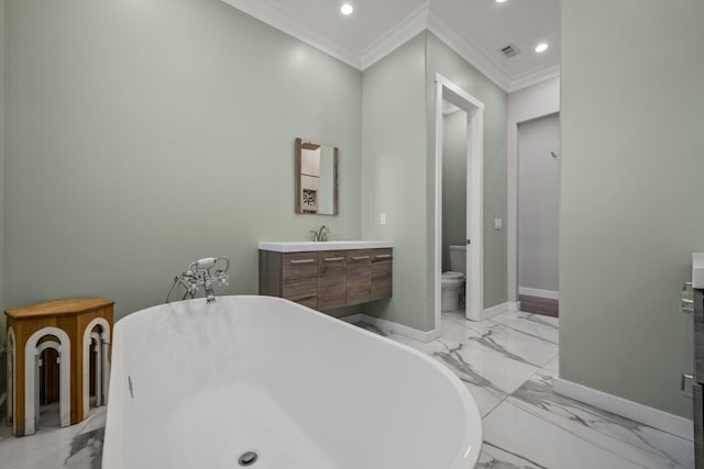 bathroom with a tub, crown molding, vanity, and toilet