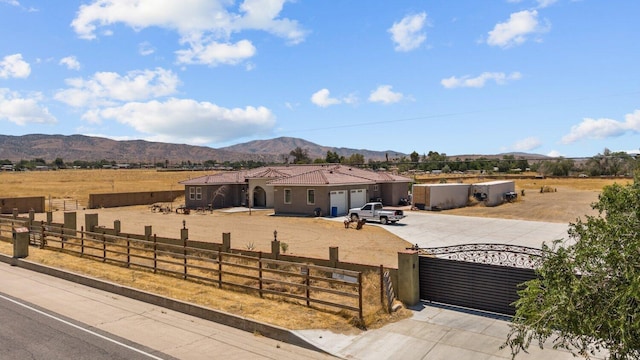 view of front of property featuring a mountain view, a rural view, and a garage