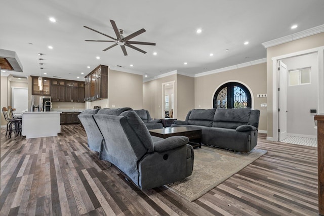 living room featuring dark hardwood / wood-style floors, ceiling fan, ornamental molding, and french doors