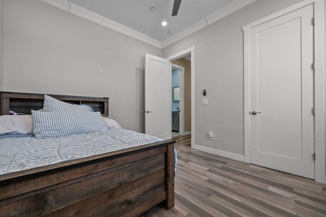 bedroom featuring ceiling fan, crown molding, and hardwood / wood-style flooring