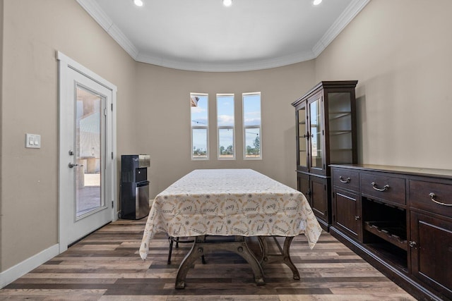 dining room featuring dark hardwood / wood-style flooring and crown molding