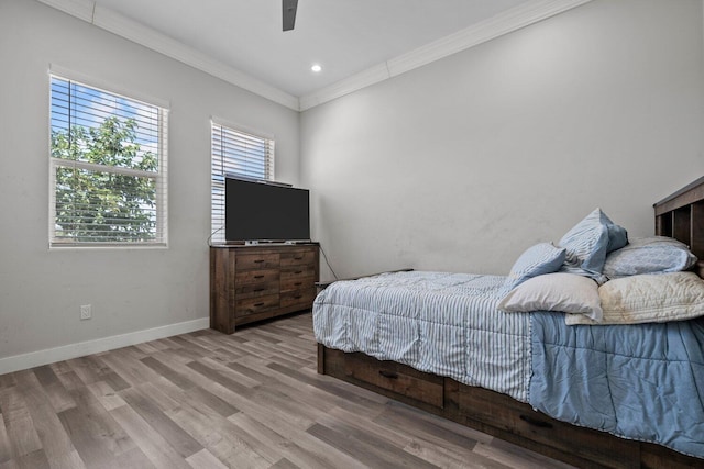 bedroom featuring light hardwood / wood-style floors, ceiling fan, and ornamental molding