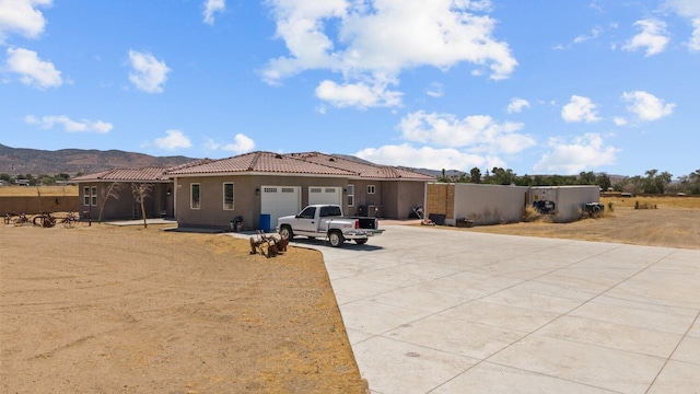 back of property featuring a mountain view and a garage