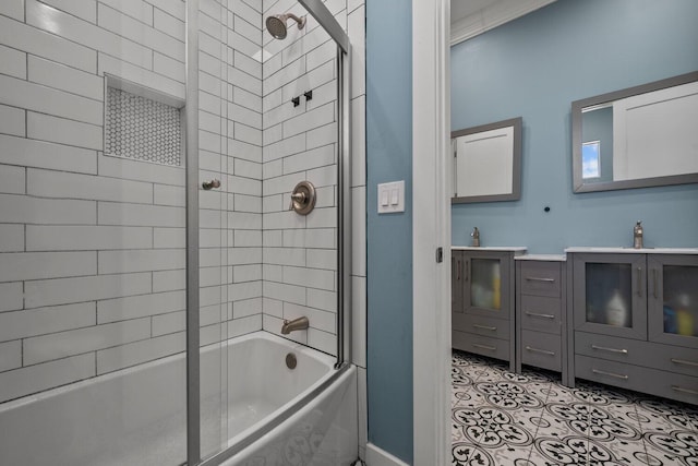 bathroom with tiled shower / bath combo, crown molding, and sink