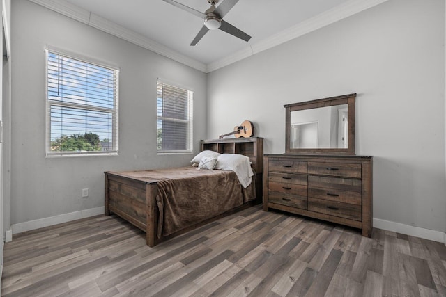 bedroom featuring ceiling fan, ornamental molding, and dark wood-type flooring