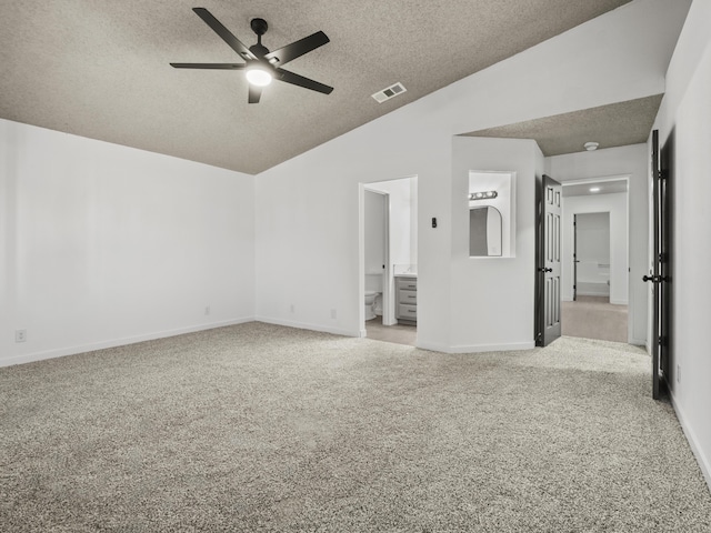 unfurnished room featuring light carpet, a textured ceiling, ceiling fan, and lofted ceiling