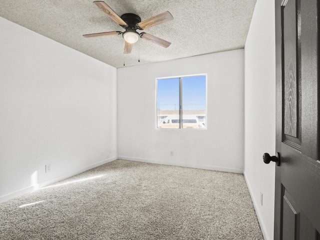 carpeted empty room featuring ceiling fan and a textured ceiling