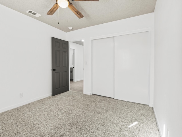 unfurnished bedroom featuring ceiling fan, a closet, and a textured ceiling