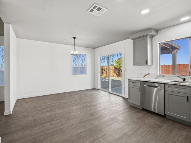 kitchen featuring a chandelier, pendant lighting, gray cabinets, and stainless steel dishwasher