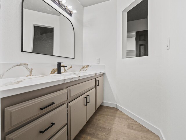 bathroom featuring vanity and hardwood / wood-style flooring