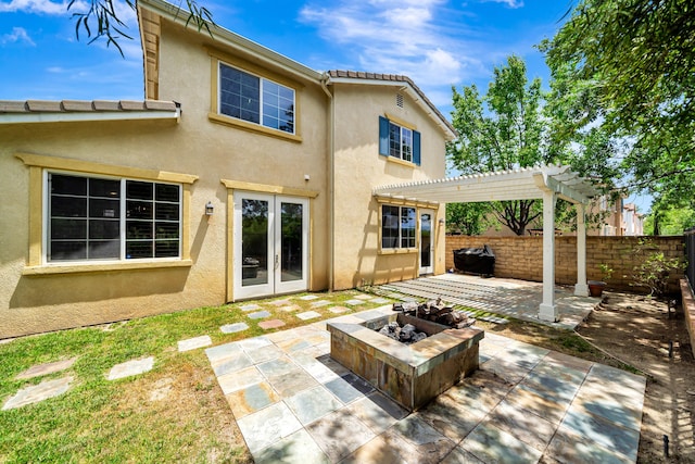 27735 Summer Grove Pl, Valencia, CA 91354 - rear view of house with stucco siding, a patio area, a fire pit, a pergola, and a tiled roof
