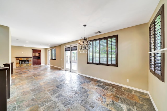 27735 Summer Grove Pl, Valencia, CA 91354 - unfurnished living room with stone tile flooring, baseboards, a chandelier, and recessed lighting