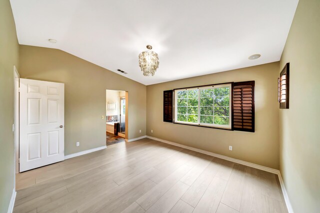 27735 Summer Grove Pl, Valencia, CA 91354 - unfurnished room with baseboards, vaulted ceiling, light wood-type flooring, and a chandelier