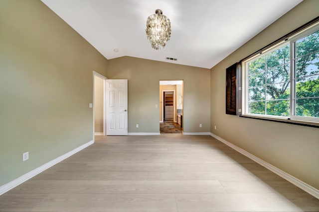 27735 Summer Grove Pl, Valencia, CA 91354 - empty room featuring light wood-style floors, lofted ceiling, baseboards, and a chandelier