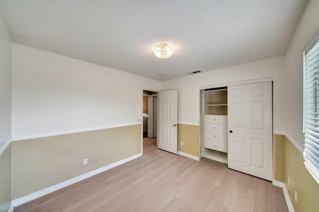 27735 Summer Grove Pl, Valencia, CA 91354 - unfurnished bedroom with light wood-type flooring, baseboards, a closet, and washer / dryer