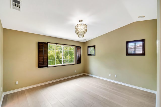 27735 Summer Grove Pl, Valencia, CA 91354 - empty room featuring a chandelier, baseboards, light wood-type flooring, and vaulted ceiling