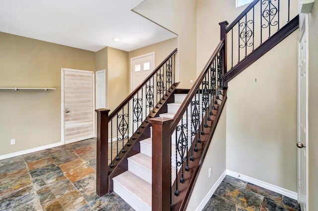 27735 Summer Grove Pl, Valencia, CA 91354 - staircase with stone tile floors and baseboards