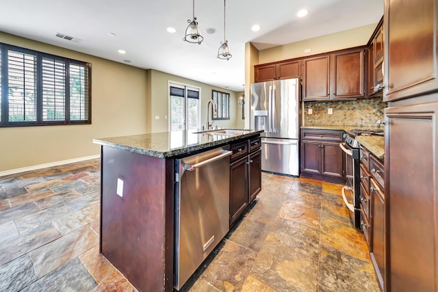 27735 Summer Grove Pl, Valencia, CA 91354 - kitchen with appliances with stainless steel finishes, a sink, stone tile floors, decorative backsplash, and dark stone counters