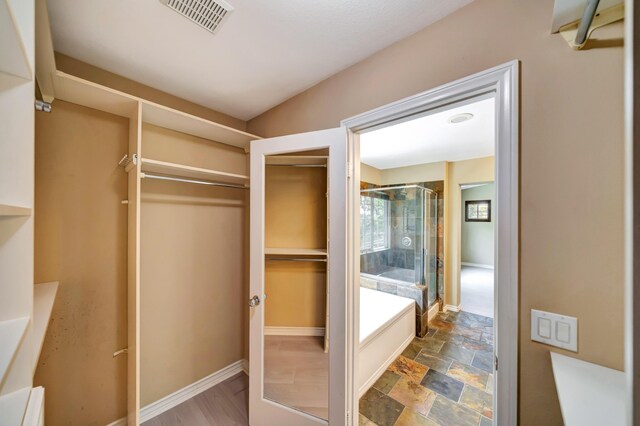 27735 Summer Grove Pl, Valencia, CA 91354 - spacious closet featuring stone finish floors