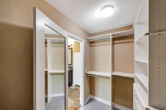 27735 Summer Grove Pl, Valencia, CA 91354 - walk in closet with light stone finish flooring
