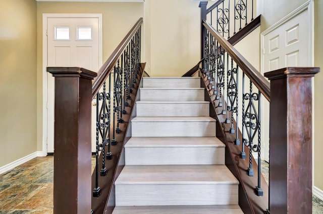 27735 Summer Grove Pl, Valencia, CA 91354 - stairway with baseboards and stone finish floors