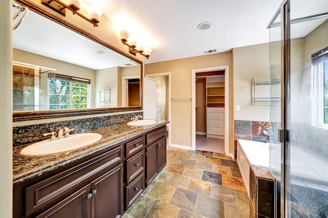 27735 Summer Grove Pl, Valencia, CA 91354 - full bathroom with double vanity, a stall shower, a bath, and stone finish floors