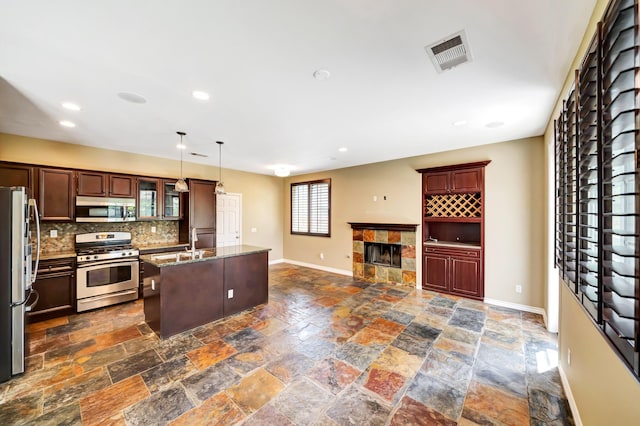 27735 Summer Grove Pl, Valencia, CA 91354 - kitchen featuring stainless steel appliances, baseboards, decorative backsplash, recessed lighting, and stone tile floors