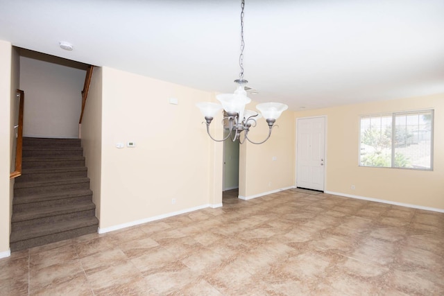 spare room featuring an inviting chandelier