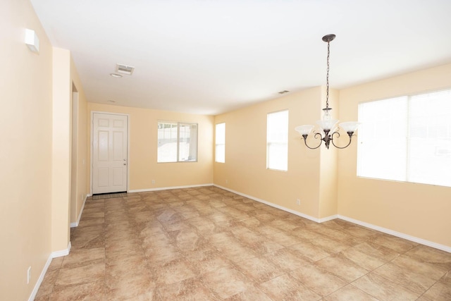 empty room featuring a chandelier