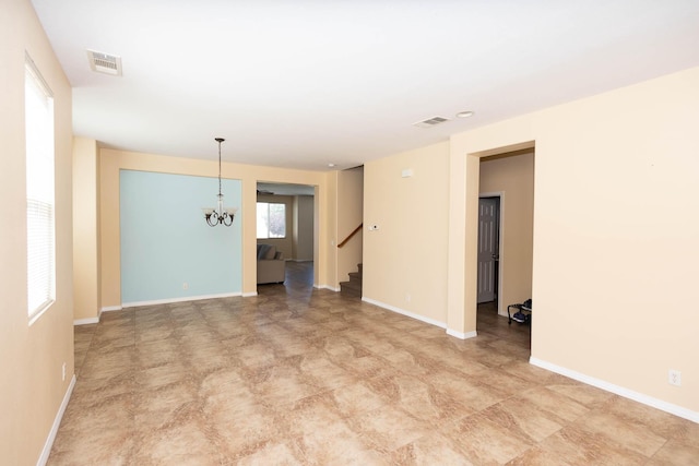 empty room featuring a chandelier