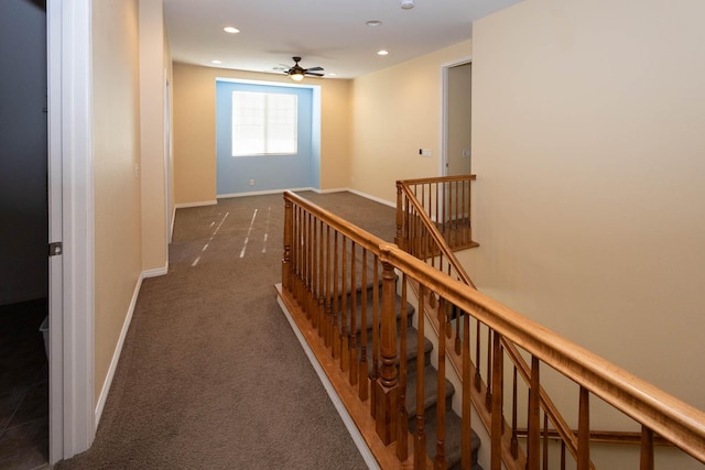 hallway featuring dark colored carpet