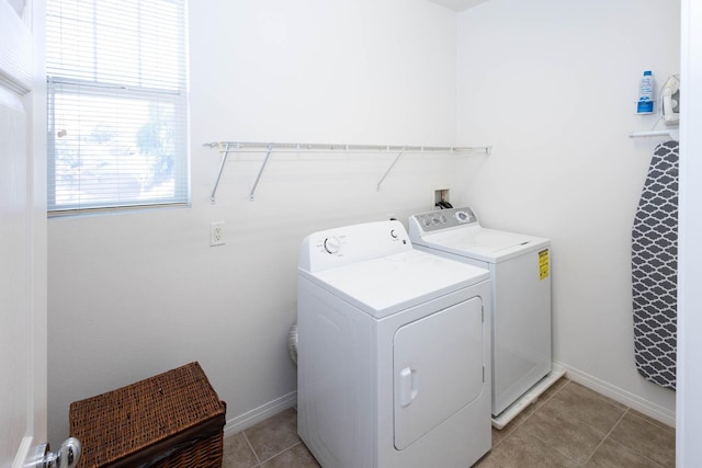 washroom with separate washer and dryer and light tile patterned floors