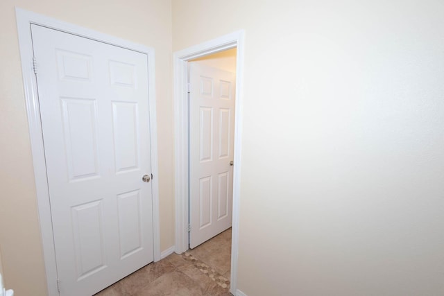 corridor featuring light tile patterned floors