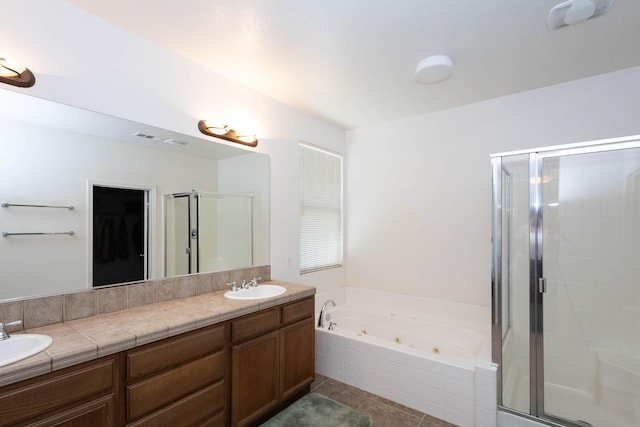 bathroom with tile patterned flooring, vanity, and separate shower and tub