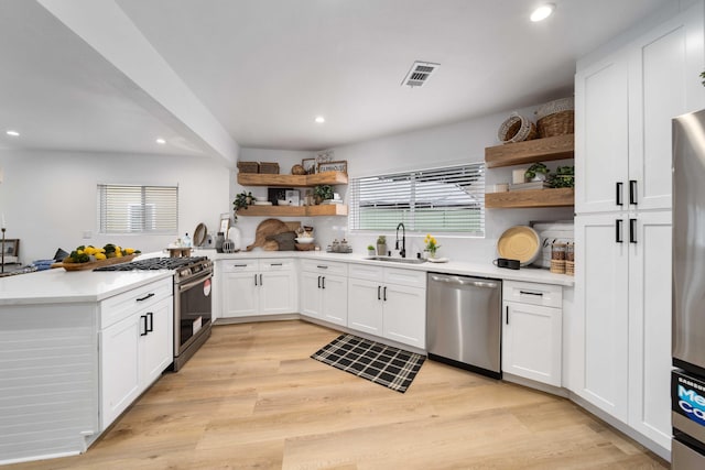 11946 Aneta St, Culver City, CA 90230 - kitchen with a sink, appliances with stainless steel finishes, open shelves, and a peninsula