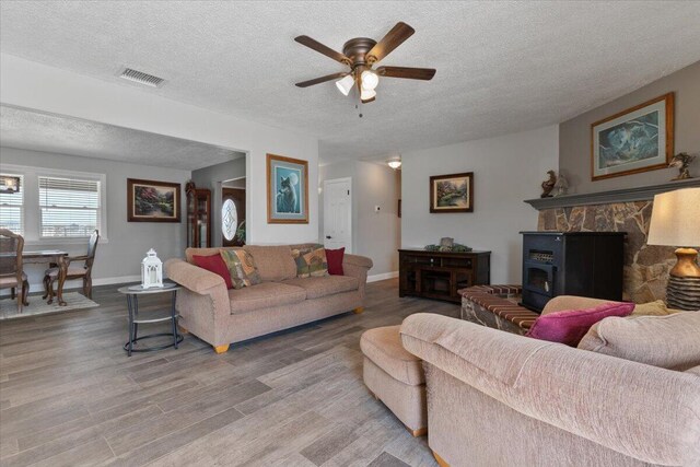 44850 E 43rd St, Lancaster, CA 93535 - living area featuring a textured ceiling, a ceiling fan, wood finished floors, and baseboards