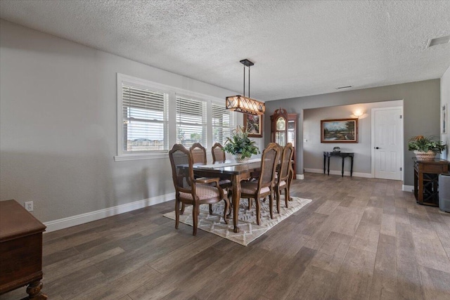 44850 E 43rd St, Lancaster, CA 93535 - dining space with wood finished floors, baseboards, healthy amount of natural light, a textured ceiling, and a chandelier