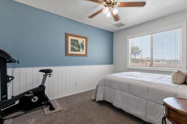 44850 E 43rd St, Lancaster, CA 93535 - bedroom with wainscoting, a textured ceiling, carpet, and ceiling fan