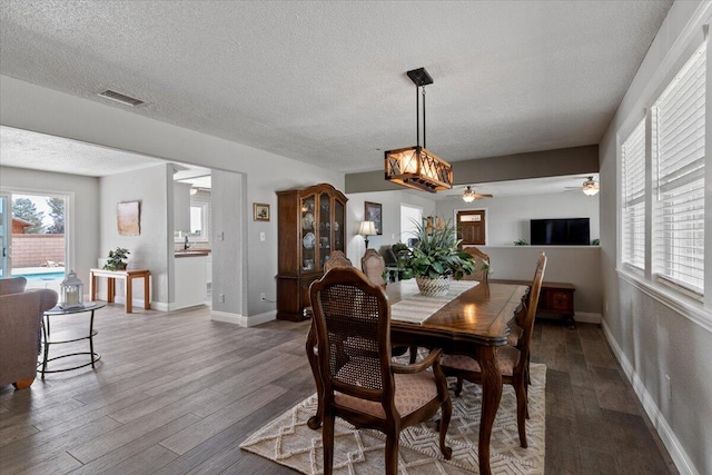 44850 E 43rd St, Lancaster, CA 93535 - dining area featuring wood finished floors, a textured ceiling, baseboards, and a ceiling fan