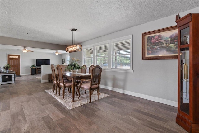 44850 E 43rd St, Lancaster, CA 93535 - dining space featuring a textured ceiling, dark wood-style floors, ceiling fan, baseboards, and a chandelier