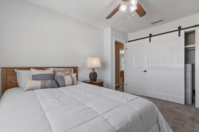 44850 E 43rd St, Lancaster, CA 93535 - carpeted bedroom with a barn door, a textured ceiling, and a ceiling fan